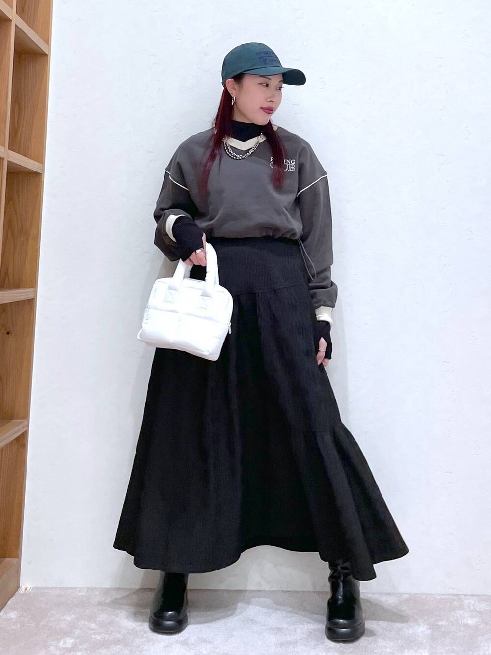 グレー系のスウェット、ブラック系のTシャツ/カットソー、ブラック系のブーツを着用したレディースの冬コーディネートの3枚目の写真