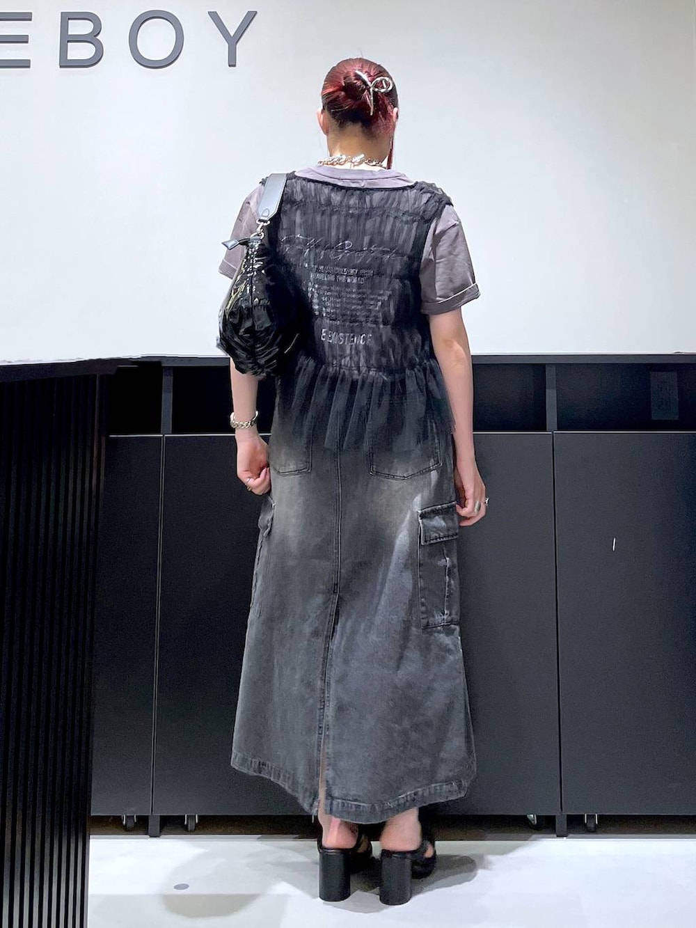 ブラック系のサンダル、ブラック系のデニムスカート、ブラック系のショルダーバッグを着用したレディースの夏コーディネートの5枚目の写真