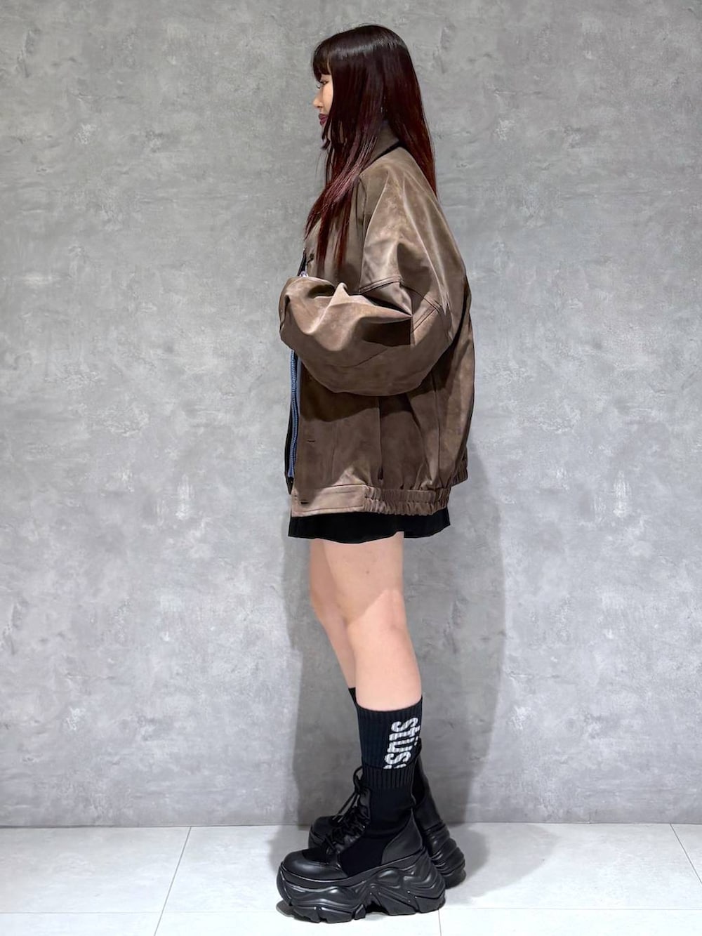 ブラック系のブーツ、ブラック系のその他パンツ、ブラウン系のブルゾンを着用したレディースの秋コーディネートの4枚目の写真