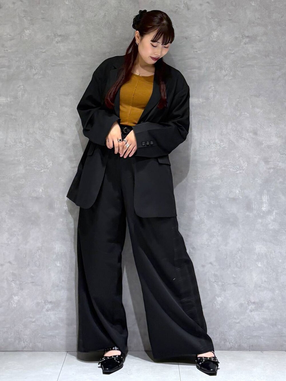 ブラック系のパンプス、ブラック系のテーラードジャケット、グレー系のスラックスを着用したレディースの秋コーディネートの8枚目の写真