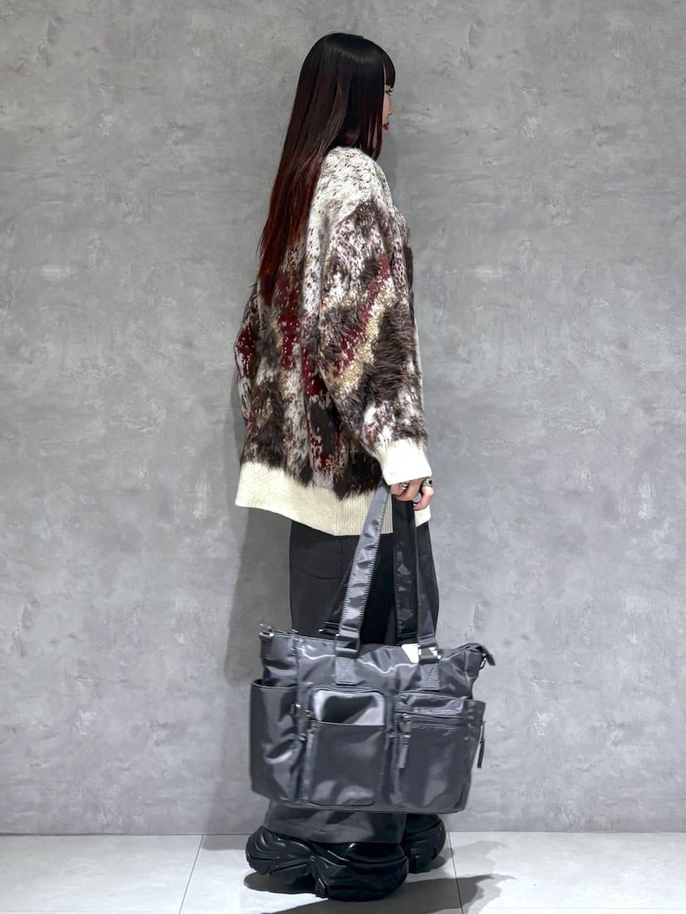 ブラック系のブーツ、グレー系のボストンバッグ、ホワイト系のカーディガン/ボレロを着用したレディースの秋コーディネートの6枚目の写真