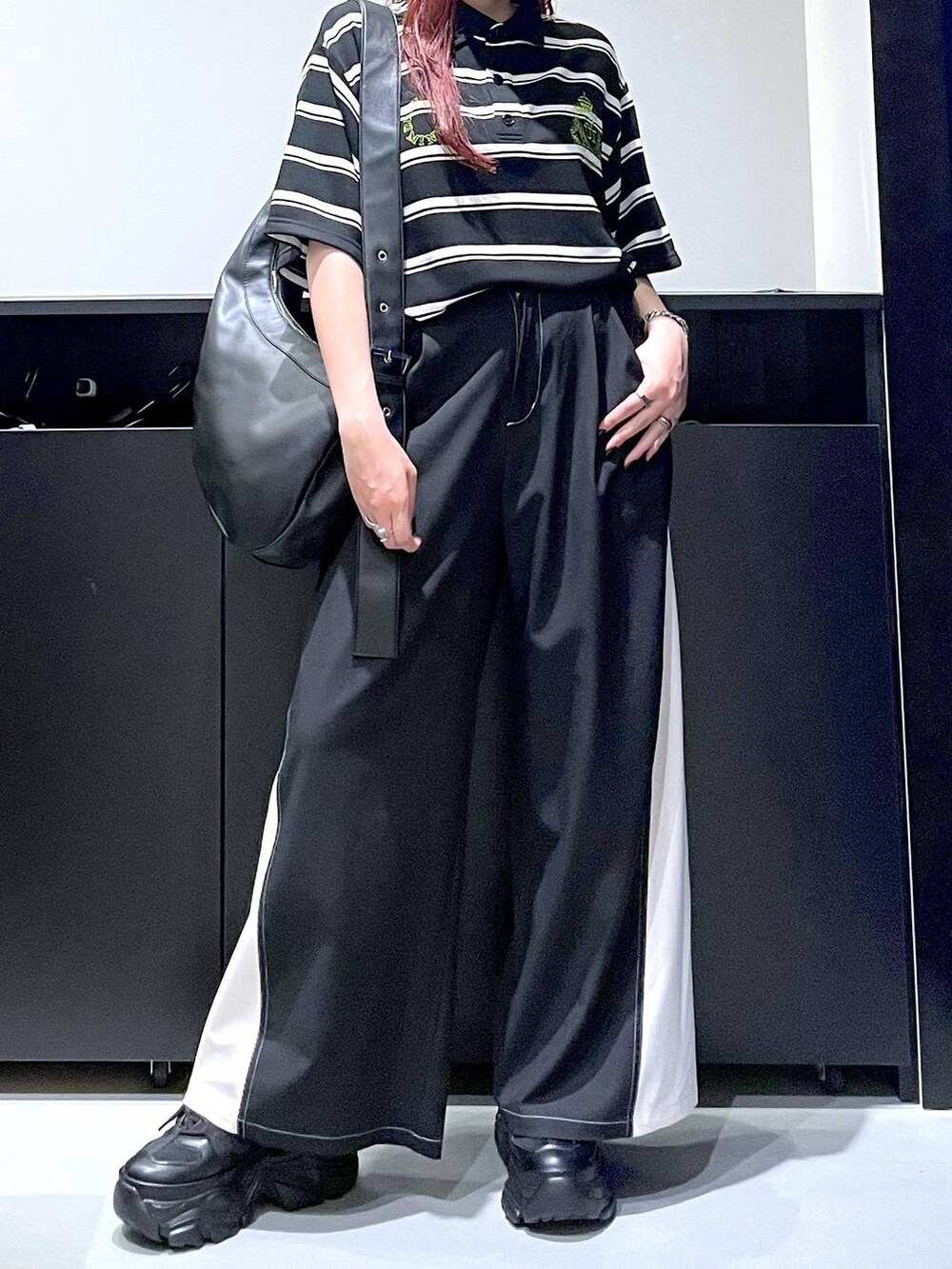 ブラック系のスニーカー、グレー系のその他パンツ、ブラック系のTシャツ/カットソーを着用したレディースの秋コーディネートの5枚目の写真