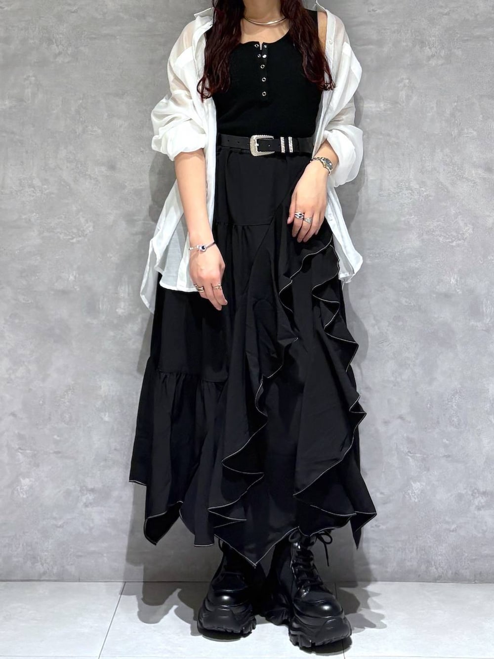 ブラック系のブーツ、ブラック系のスカート、ホワイト系のシャツ/ブラウスを着用したレディースの春コーディネートの7枚目の写真