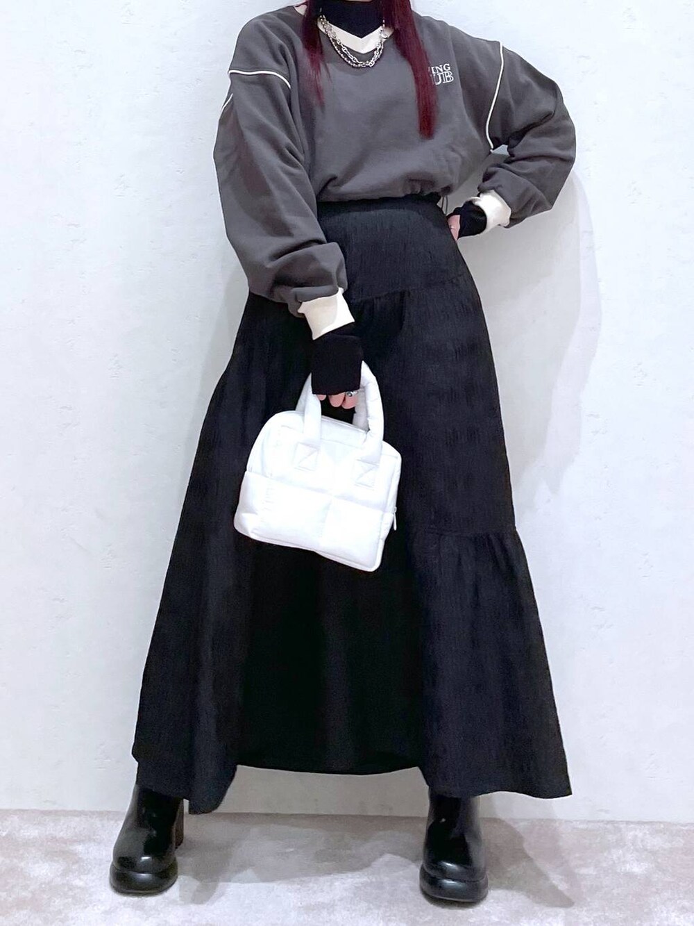 グレー系のスウェット、ブラック系のTシャツ/カットソー、ブラック系のブーツを着用したレディースの冬コーディネートの4枚目の写真