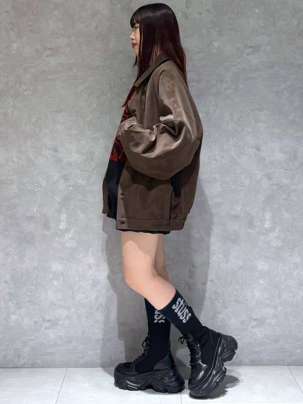 ブラック系のブーツ、ブラウン系のブルゾン、ブラック系のニット/セーターを着用したレディースの秋コーディネートの4枚目の写真