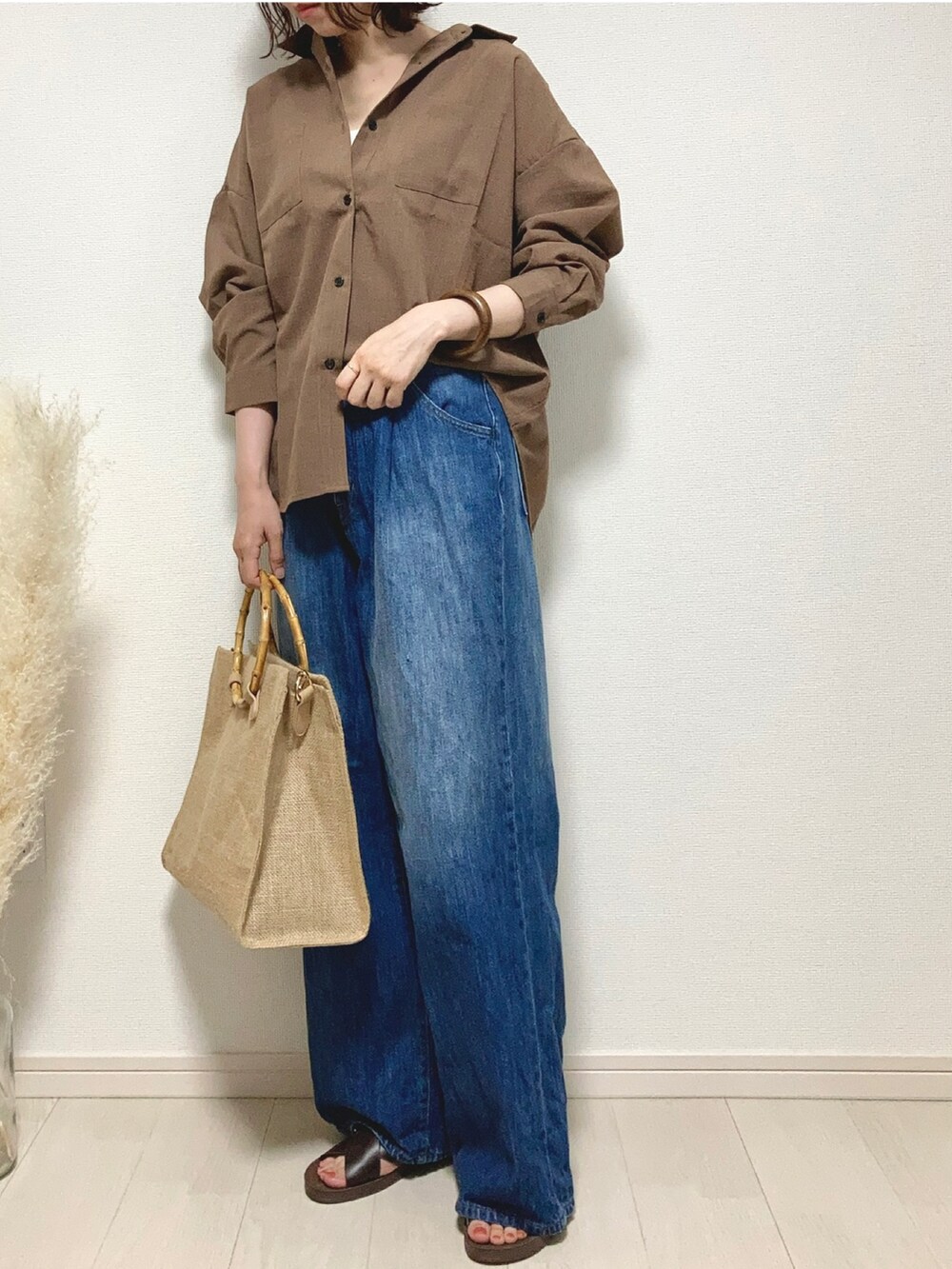 ブラウン系のシャツ/ブラウス、ブルー系のデニムパンツ、ブラウン系のサンダルを着用したレディースの夏コーディネートの2枚目の写真