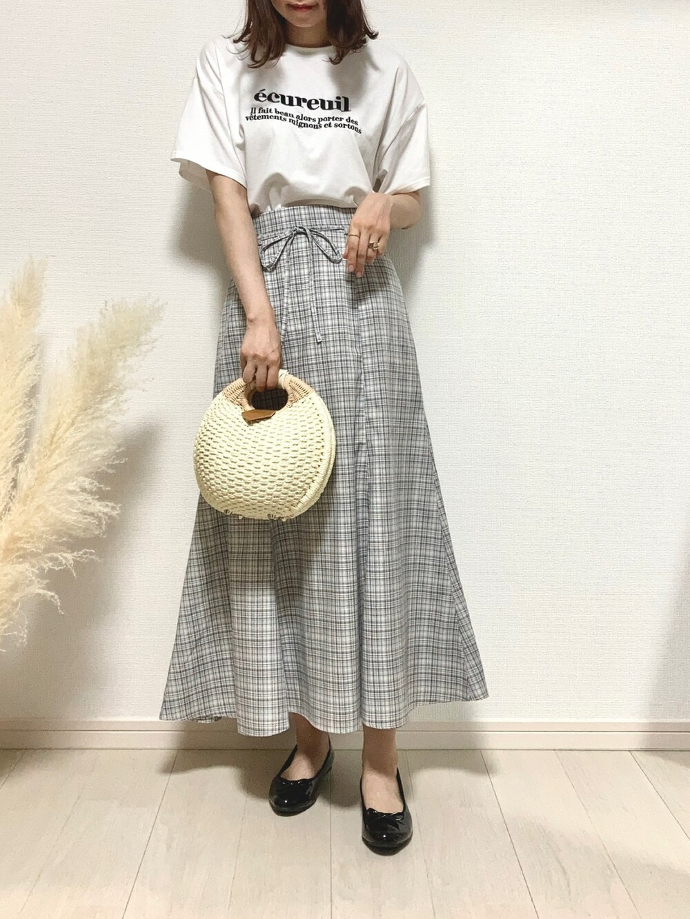 ブラウン系のカーディガン/ボレロ、ホワイト系のTシャツ/カットソー、グレー系のスカートを着用したレディースの秋コーディネートの3枚目の写真