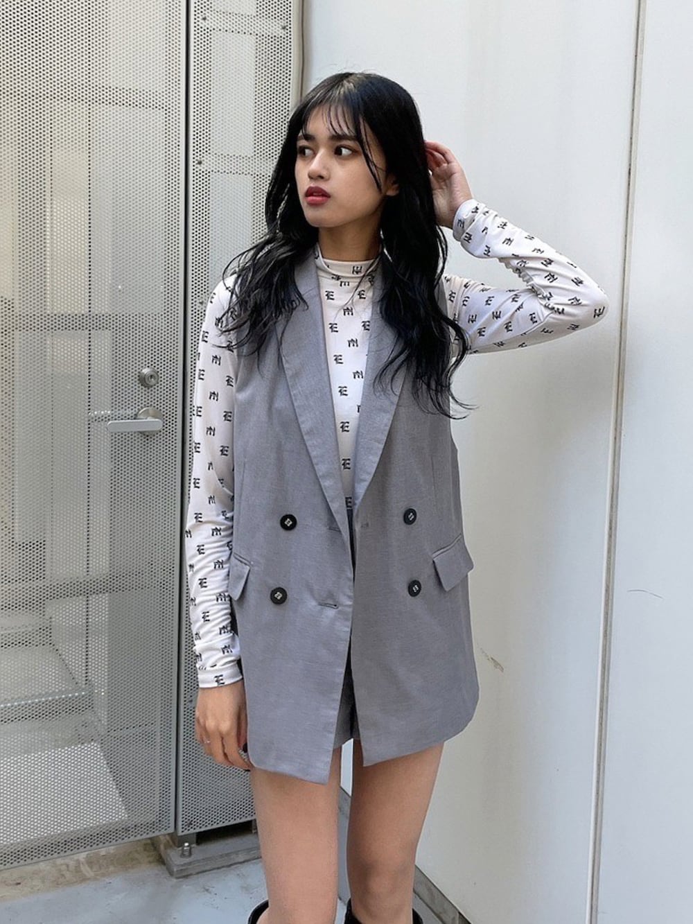 ブラック系のベスト、ブラック系のその他パンツ、ブラック系のブーツを着用したレディースの春コーディネートの2枚目の写真