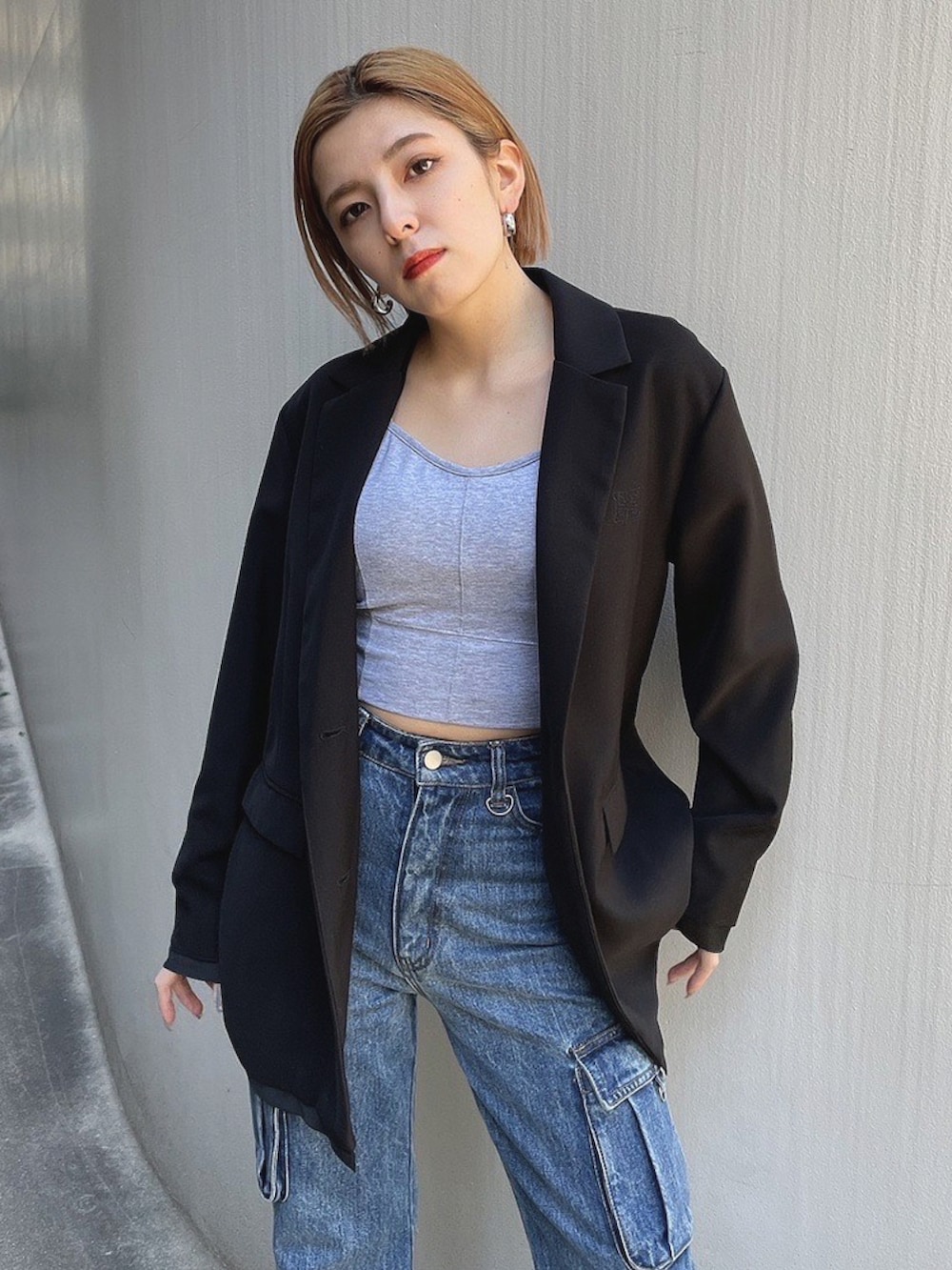 ブラック系のテーラードジャケット、ブルー系のデニムパンツ、ブラック系のローファーを着用したレディースの春コーディネートの3枚目の写真