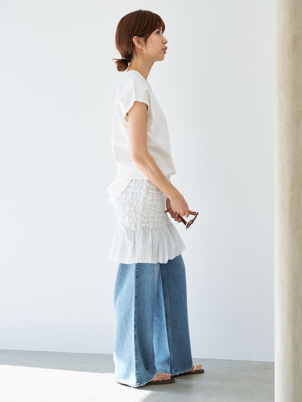 ホワイト系のスカート、ホワイト系のTシャツ/カットソー、ブラウン系のサンダルを着用したレディースの春コーディネートの5枚目の写真