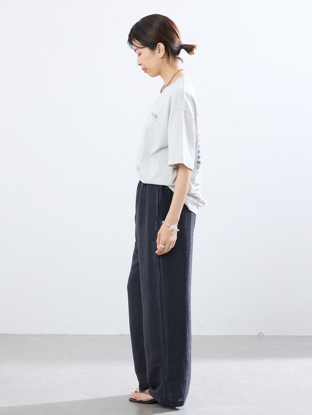 ブルー系のその他パンツ、グレー系のTシャツ/カットソー、ブラウン系のサンダルを着用したレディースの夏コーディネートの2枚目の写真