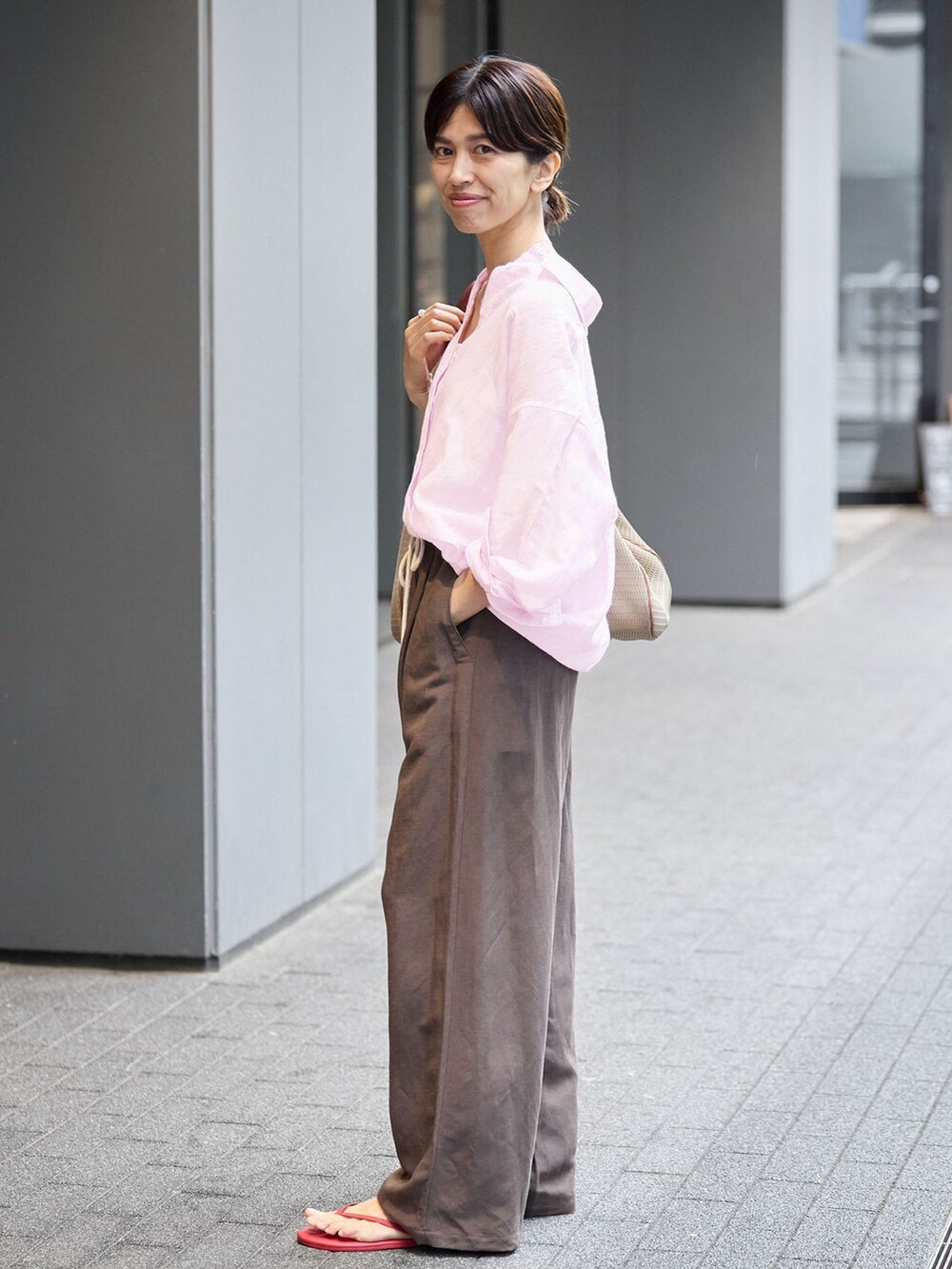 ブラウン系のその他パンツ、ピンク系のシャツ/ブラウス、レッド系のサンダルを着用したレディースの夏コーディネートの2枚目の写真