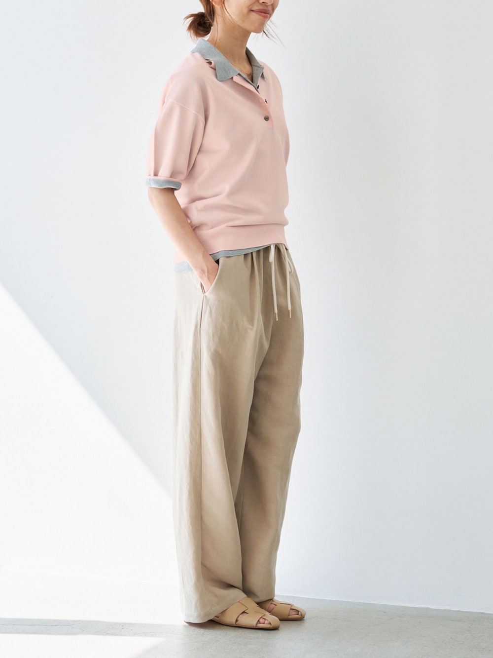 ベージュ系のその他パンツ、グレー系のニット/セーター、ピンク系のニット/セーターを着用したレディースの春コーディネートの5枚目の写真