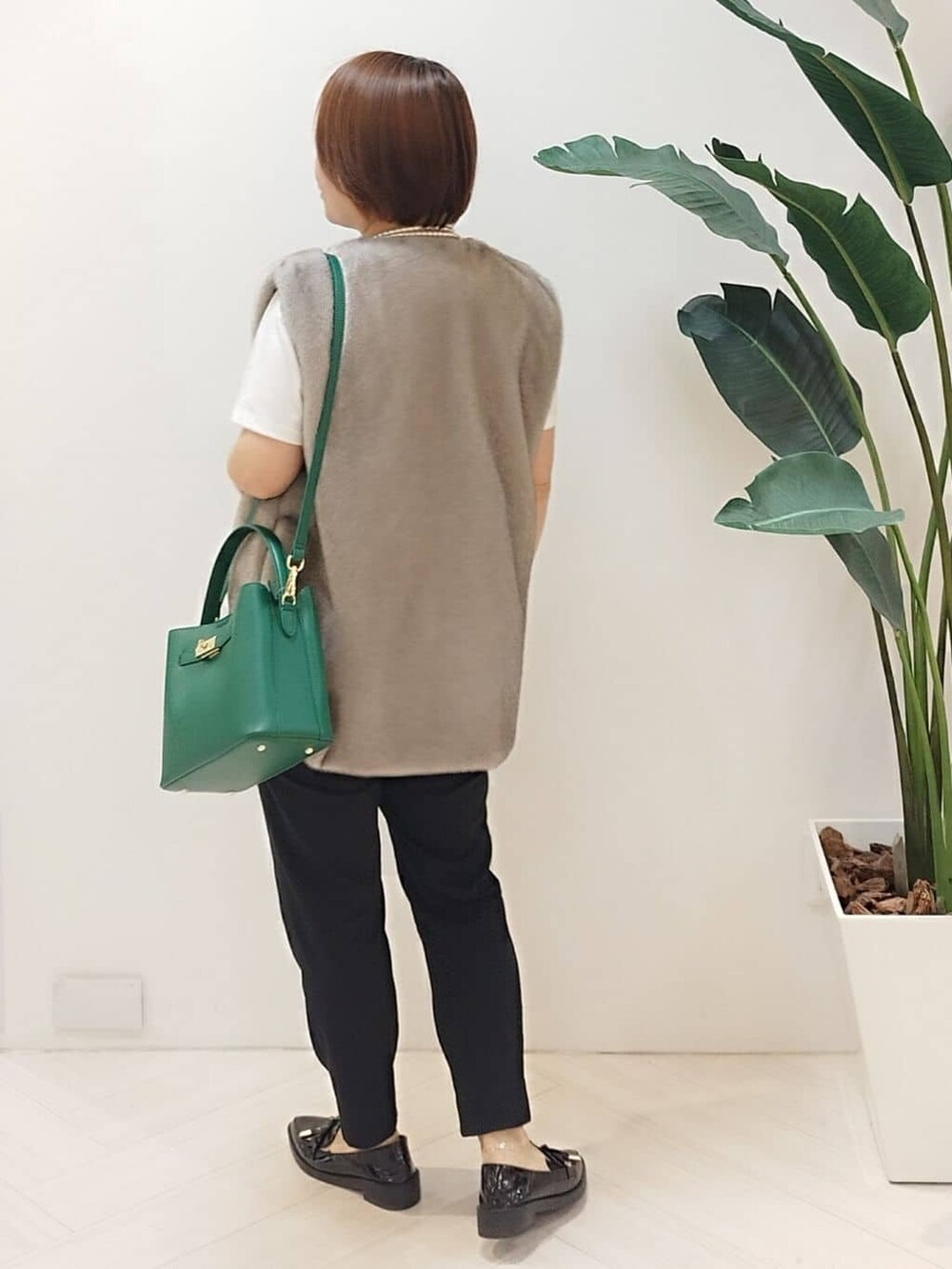 ベージュ系のベスト、ホワイト系のTシャツ/カットソー、ブラック系のその他パンツを着用したレディースの秋コーディネートの6枚目の写真