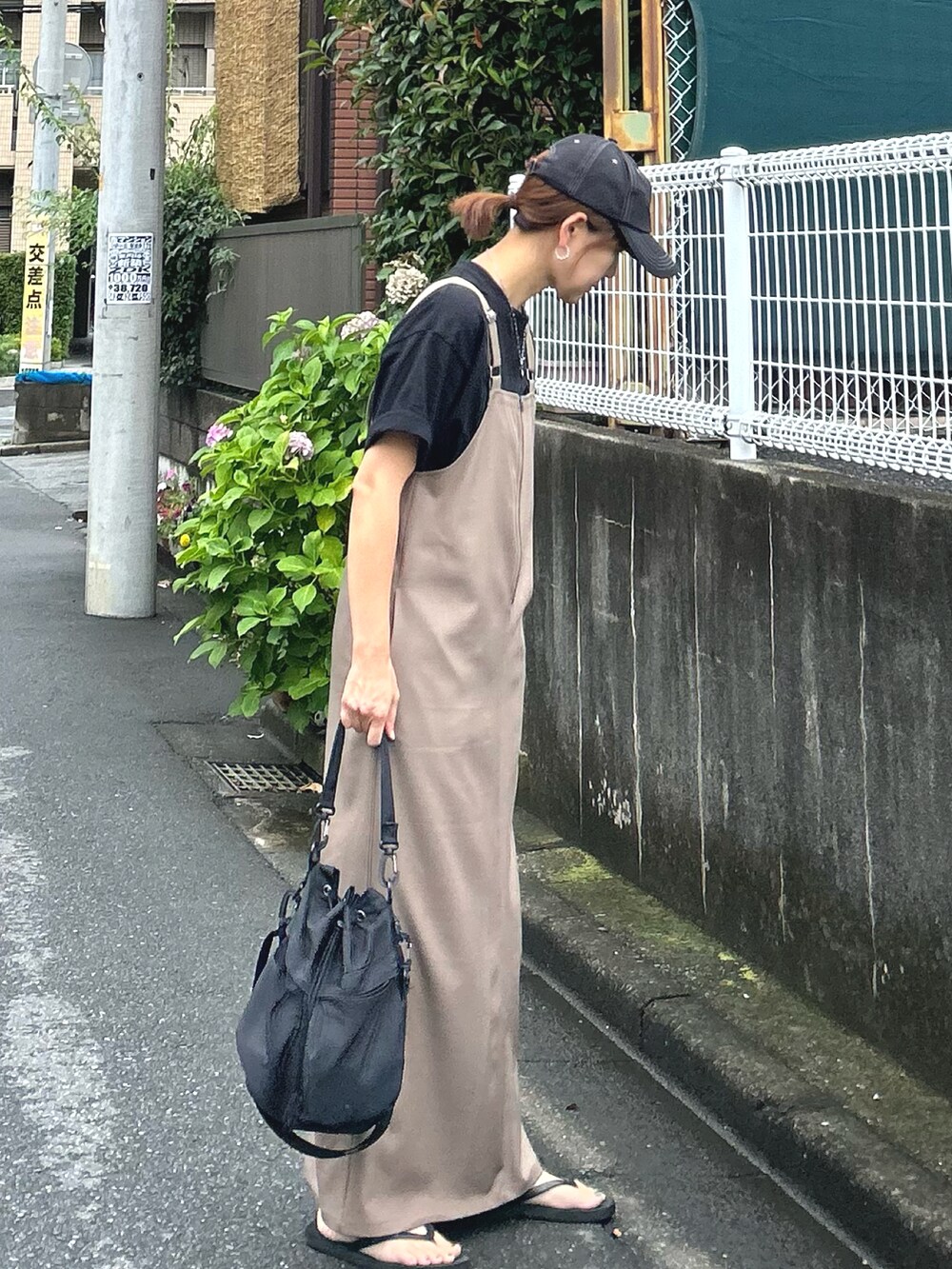 ベージュ系のワンピース、ブラック系のTシャツ/カットソー、ブラック系のショルダーバッグを着用したレディースの夏コーディネートの2枚目の写真