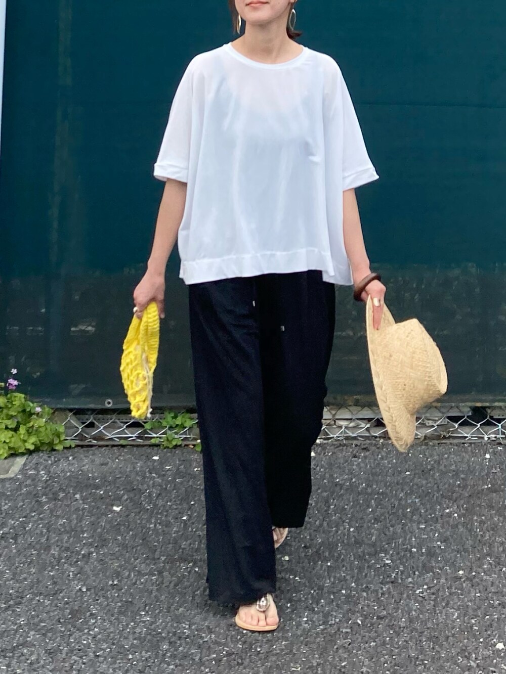 ホワイト系のTシャツ/カットソー、ブラック系のその他パンツ、イエロー系のハンドバッグを着用したレディースの春コーディネートの4枚目の写真