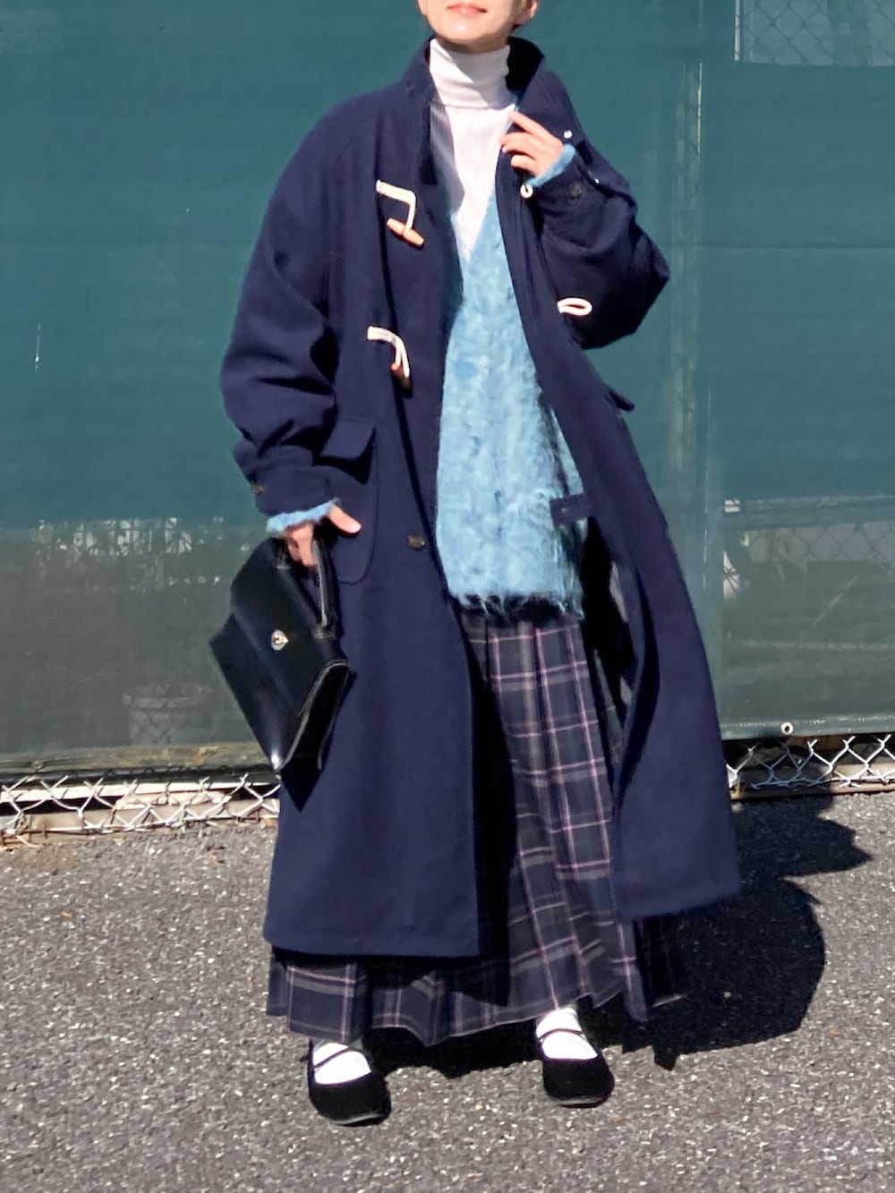 ブルー系のダッフルコート、ブルー系のカーディガン/ボレロ、ブルー系のスカートを着用したレディースの秋コーディネートの3枚目の写真
