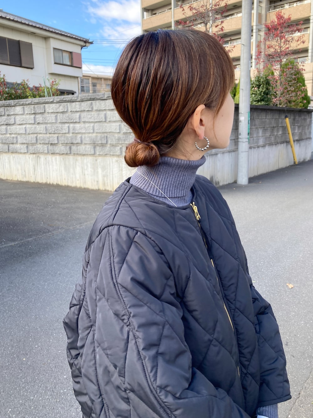 ブラック系のその他アウター、グレー系のニット/セーター、ホワイト系のスカートを着用したレディースの秋コーディネートの4枚目の写真