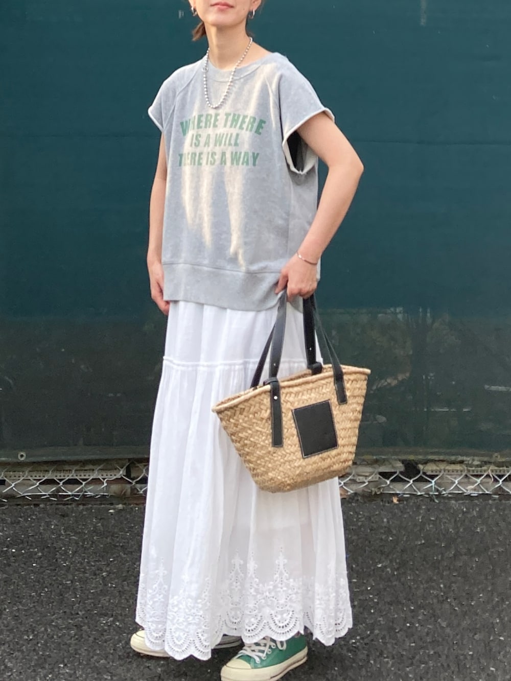 グレー系のTシャツ/カットソー、ホワイト系のスカート、ブラック系のかごバッグを着用したレディースの夏コーディネートの4枚目の写真