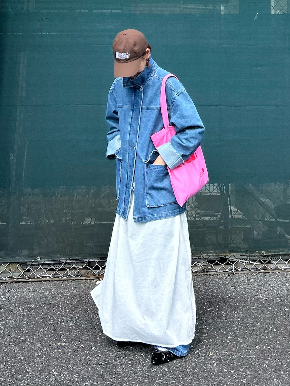 ブルー系のデニムジャケット、ホワイト系のワンピース、ピンク系のトートバッグを着用したレディースの春コーディネートの4枚目の写真