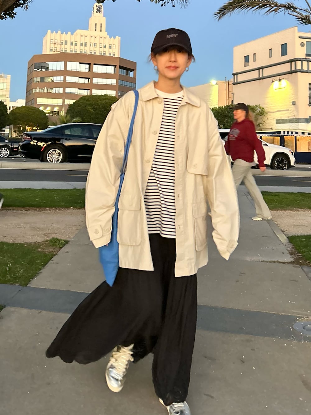 ホワイト系のブルゾン、ホワイト系のTシャツ/カットソー、ブラック系のスカートを着用したレディースの冬コーディネートの4枚目の写真