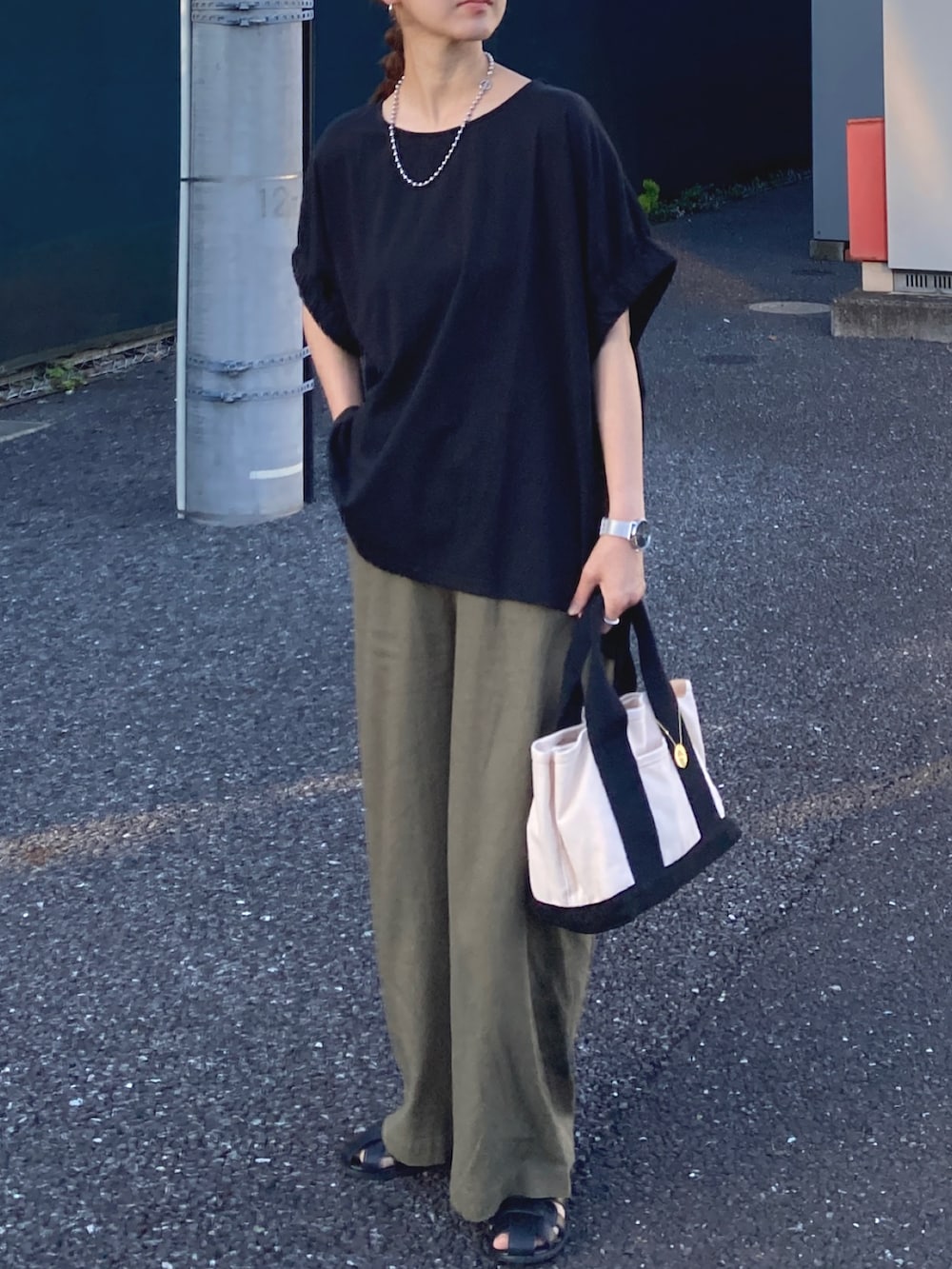 ブラック系のTシャツ/カットソー、グリーン系のその他パンツ、ホワイト系のトートバッグを着用したレディースの夏コーディネートの3枚目の写真