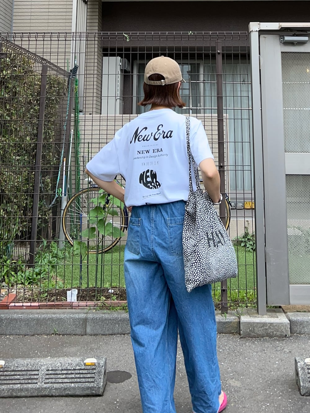 ブルー系のデニムパンツ、ホワイト系のTシャツ/カットソー、パープル系のサンダルを着用したレディースの夏コーディネートの3枚目の写真