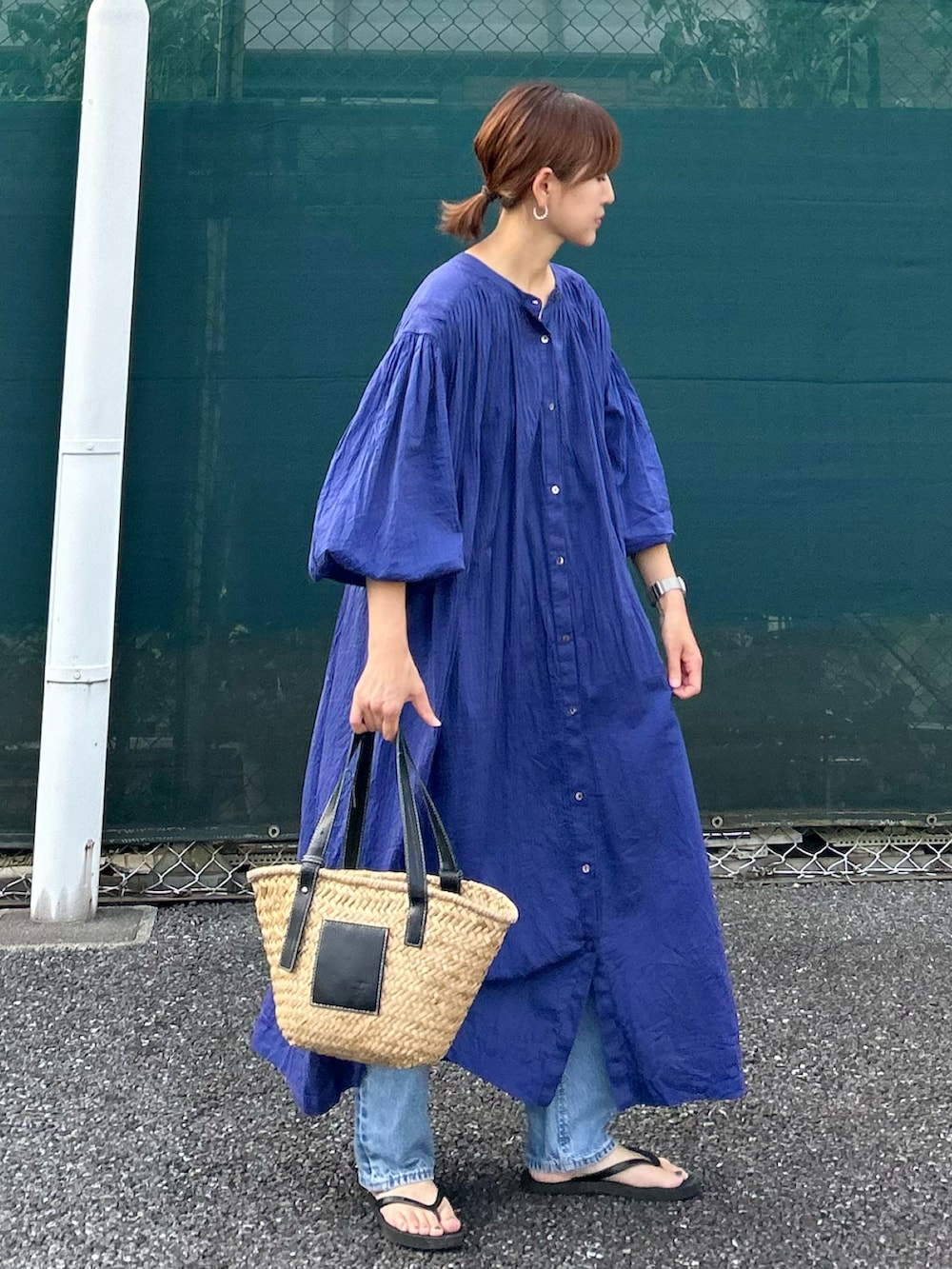 ブルー系のワンピース、ブラック系のかごバッグを着用したレディースの夏コーディネートの3枚目の写真