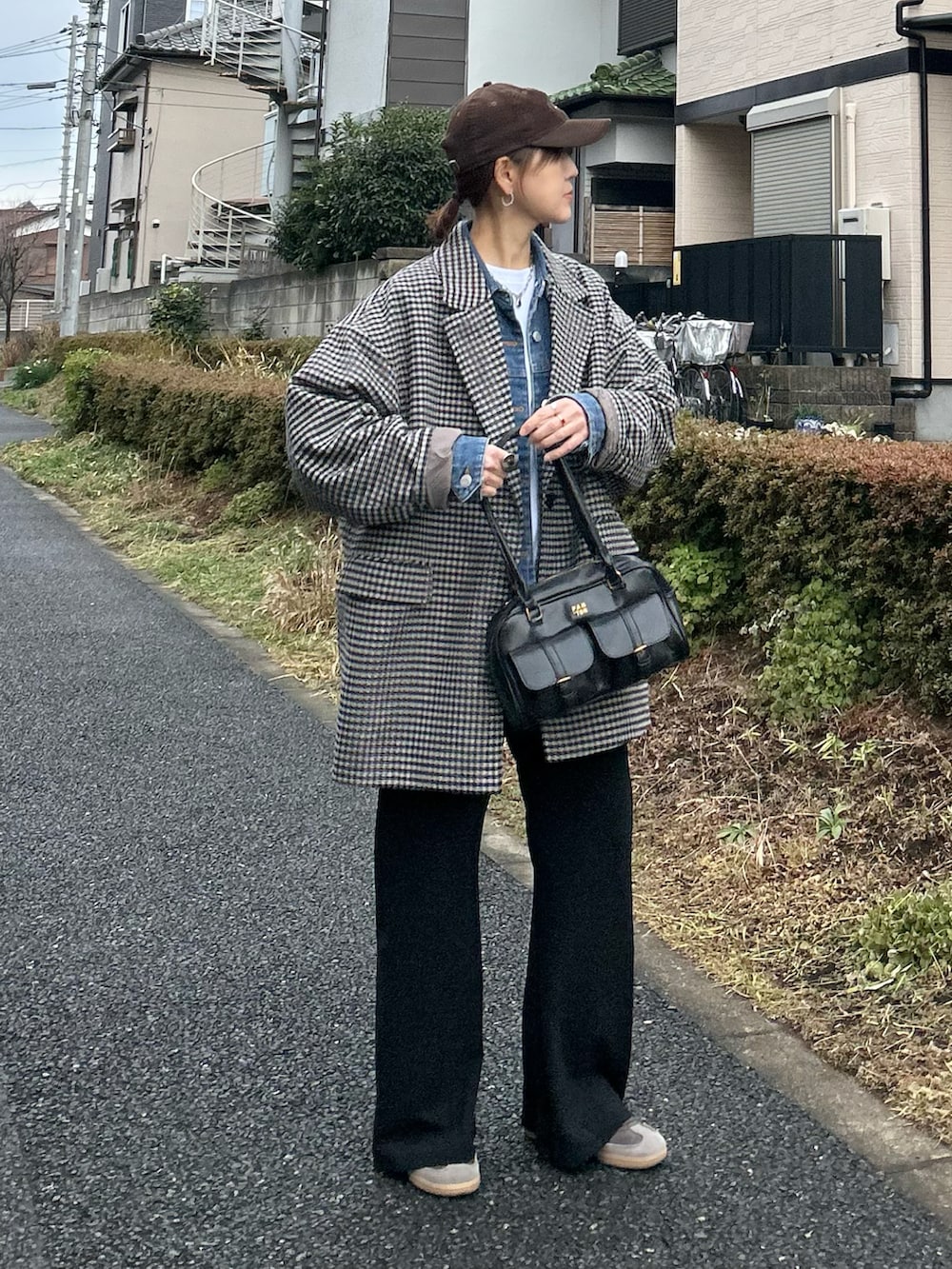 ホワイト系のTシャツ/カットソー、ブラック系のスラックス、ブラック系のハンドバッグを着用したレディースの冬コーディネートの4枚目の写真