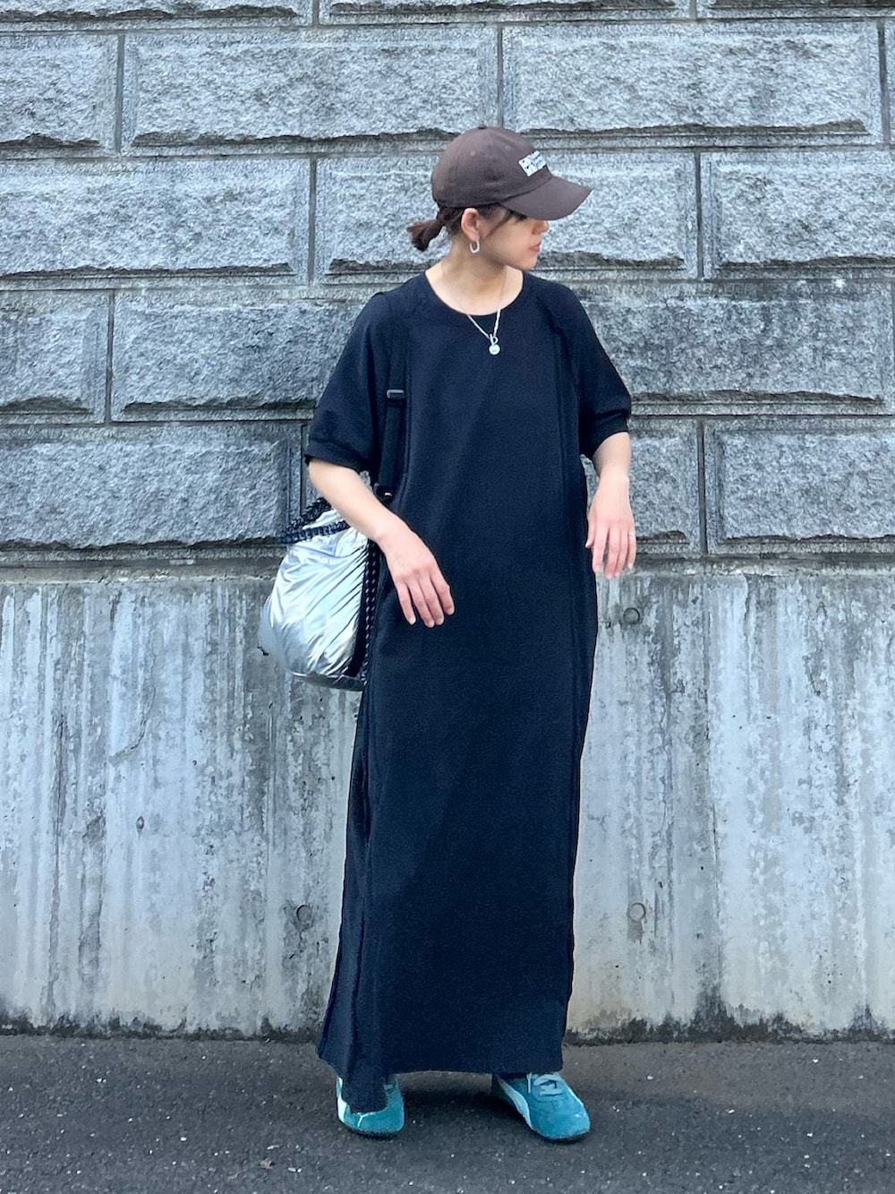 ブラック系のワンピース、シルバー系のトートバッグ、グリーン系のスニーカーを着用したレディースの夏コーディネートの4枚目の写真