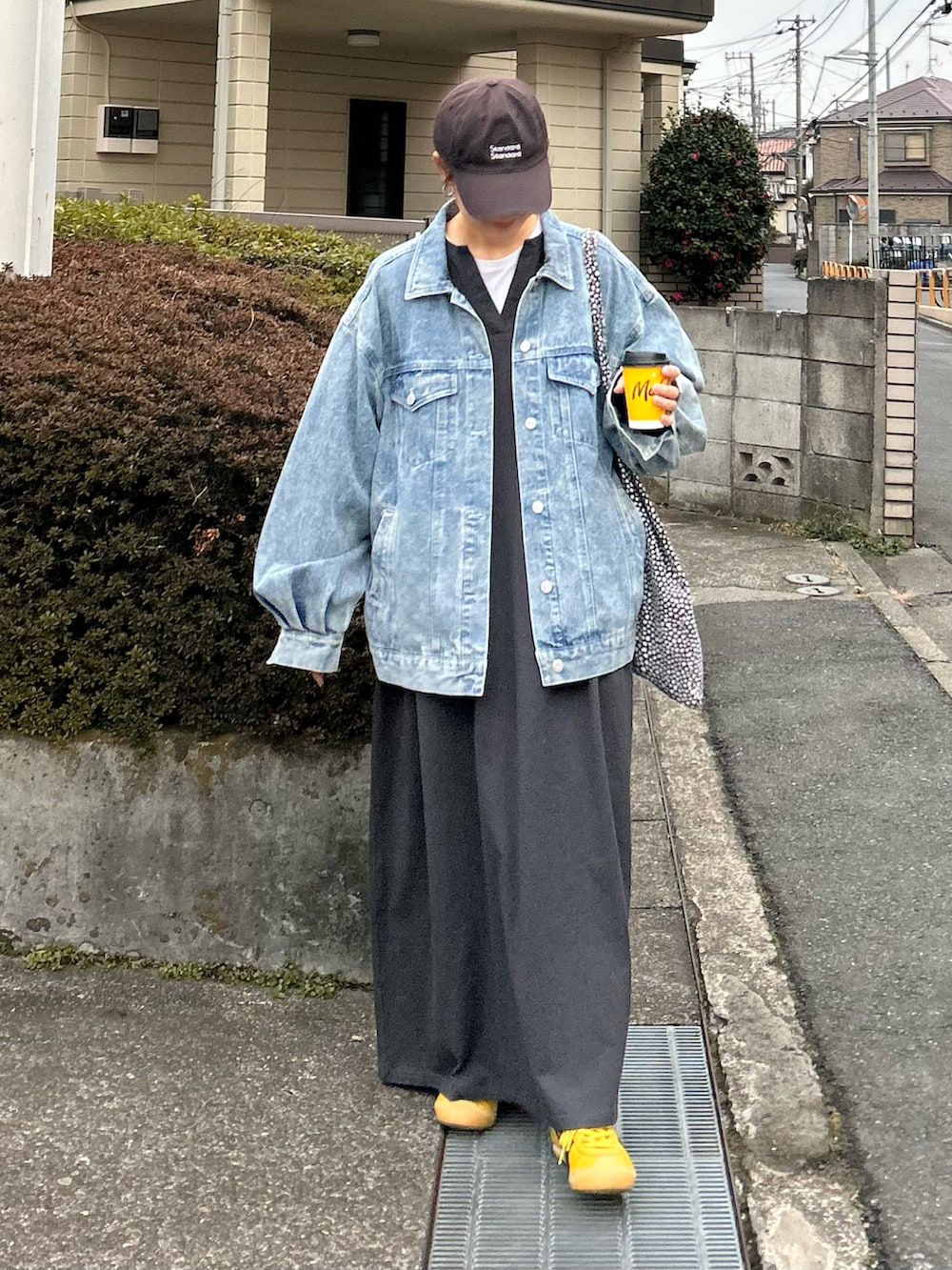ブルー系のデニムジャケット、グレー系のワンピース、イエロー系のスニーカーを着用したレディースの冬コーディネートの4枚目の写真
