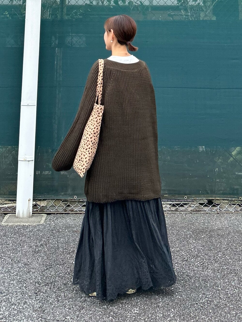 ブラウン系のニット/セーター、ブラック系のスカートを着用したレディースの冬コーディネートの5枚目の写真