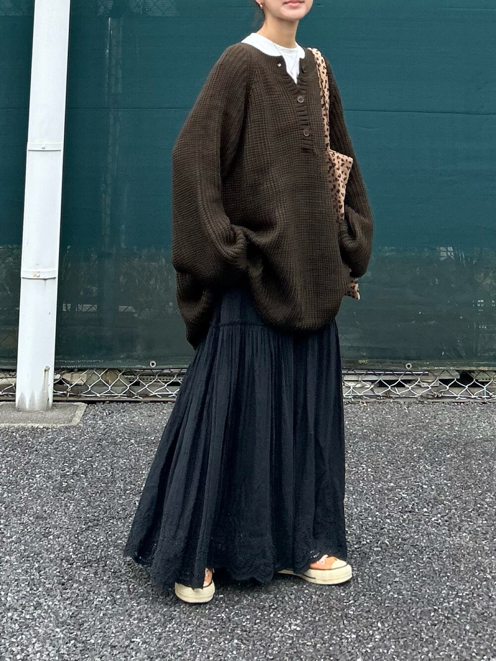 ブラウン系のニット/セーター、ブラック系のスカートを着用したレディースの冬コーディネートの4枚目の写真