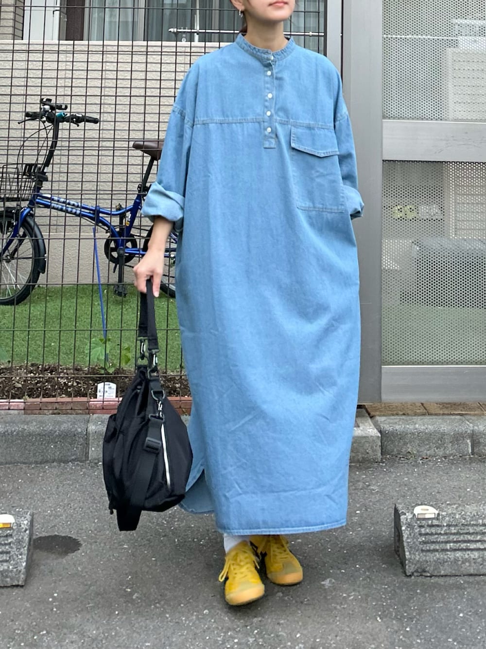 ブルー系のワンピース、ブラック系のショルダーバッグを着用したレディースの春コーディネートの4枚目の写真