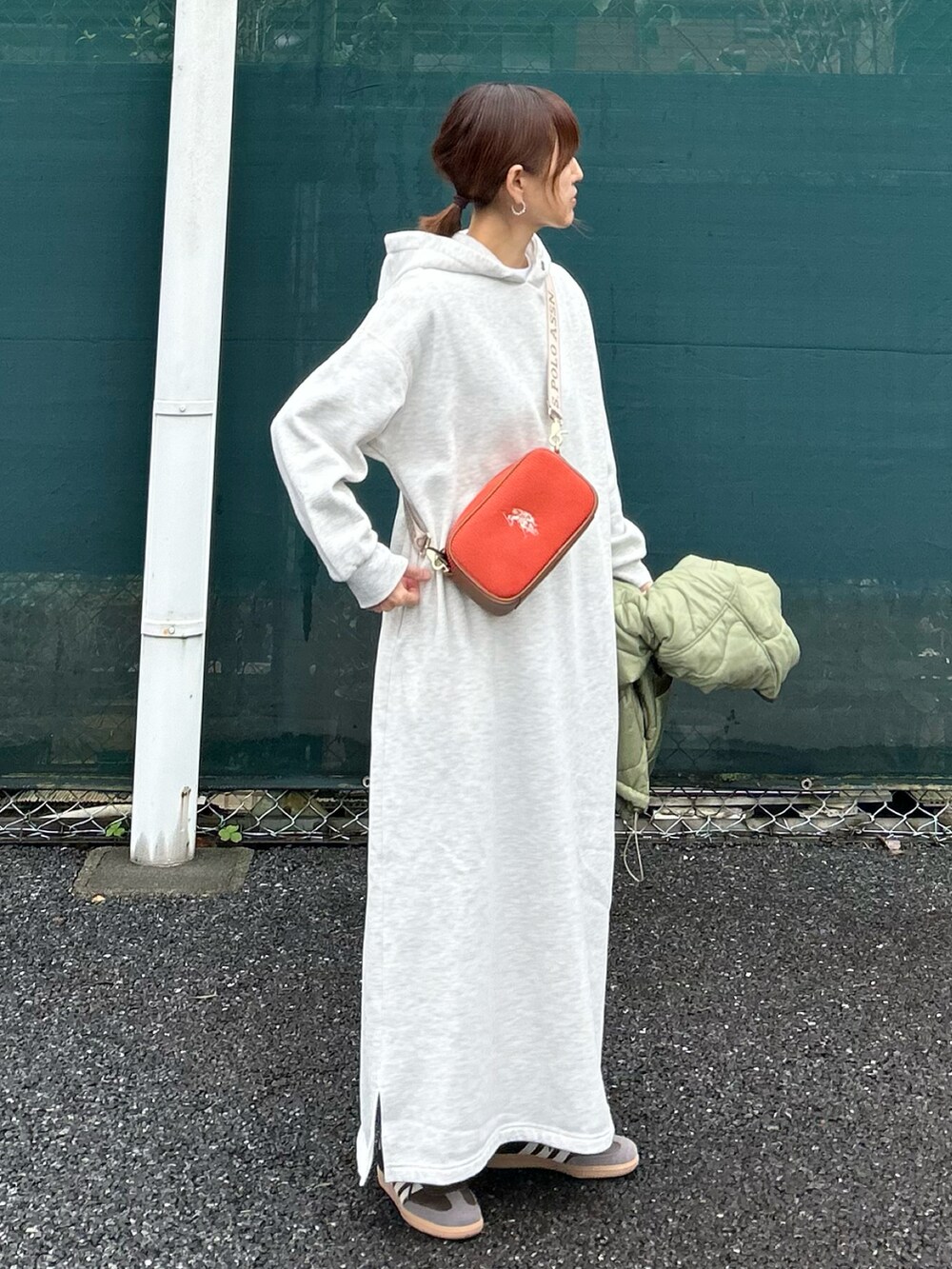 オレンジ系のショルダーバッグ、グレー系のワンピース、グリーン系のノーカラージャケットを着用したレディースの秋コーディネートの2枚目の写真