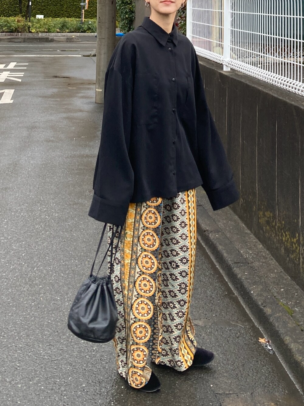 ブラック系のシャツ/ブラウス、イエロー系のその他パンツを着用したレディースの冬コーディネートの2枚目の写真