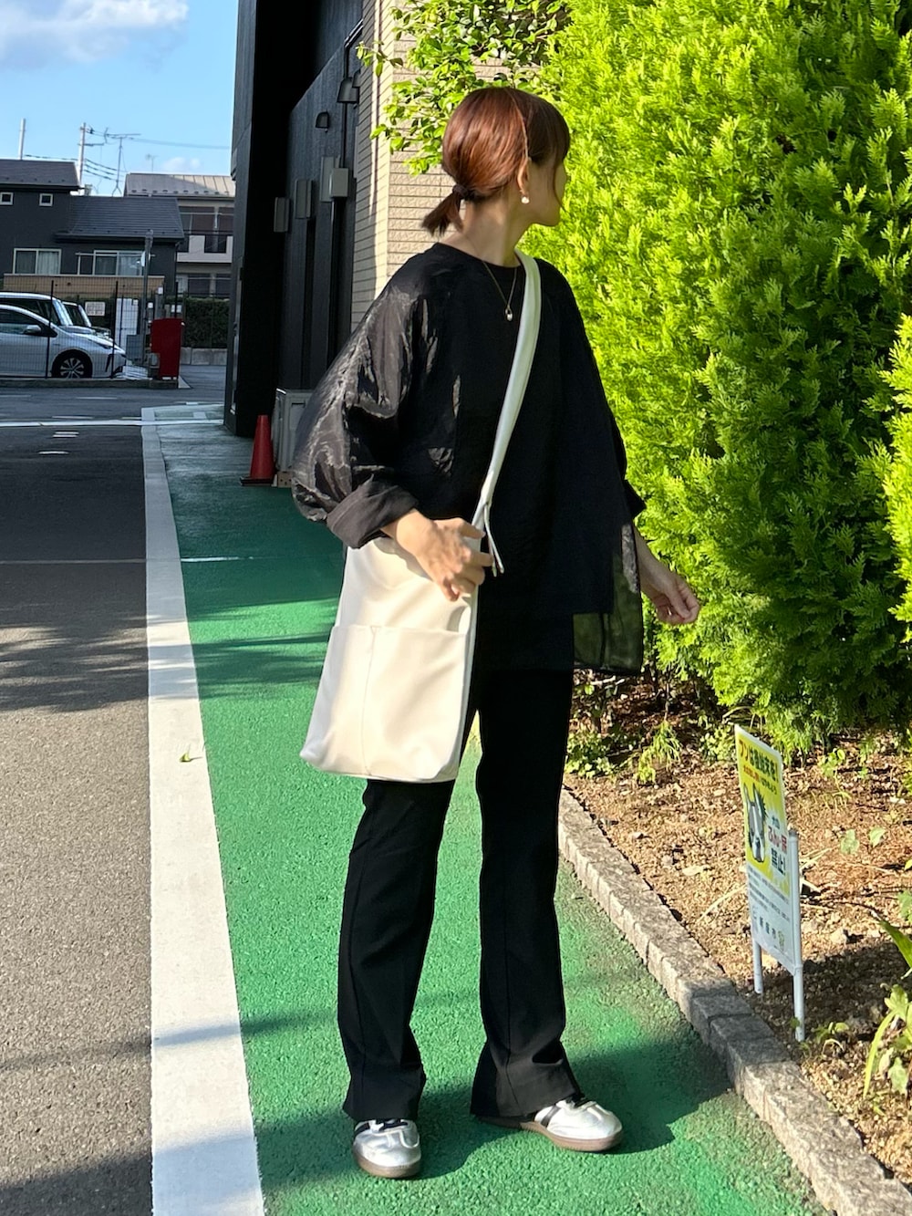 ブラック系のTシャツ/カットソー、ブラック系のその他パンツ、ホワイト系のショルダーバッグを着用したレディースの秋コーディネートの4枚目の写真