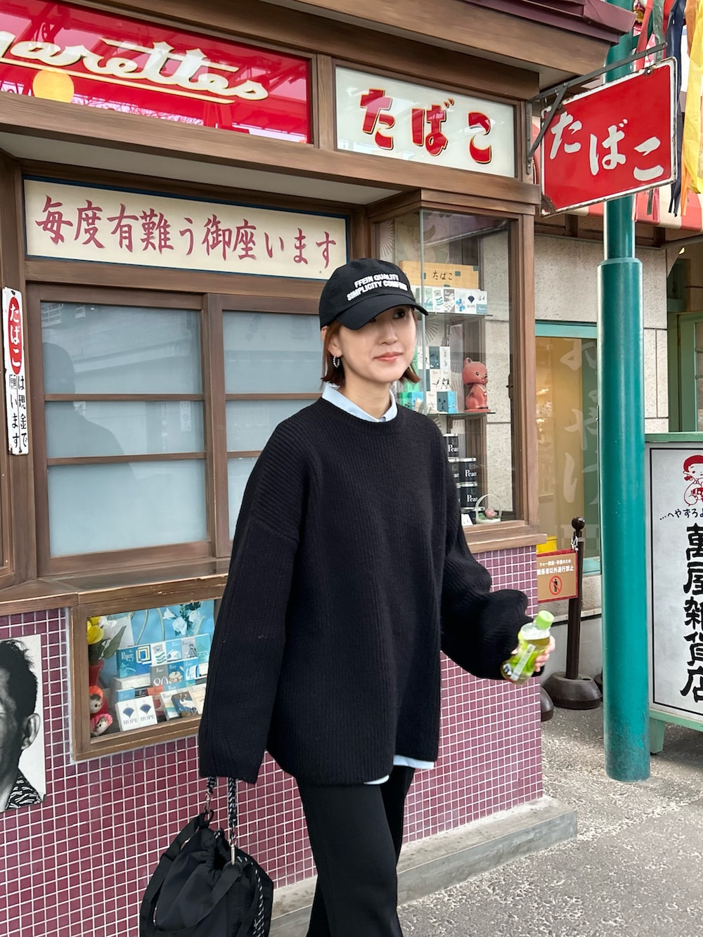 ブラック系のニット/セーター、ブラック系のその他パンツ、ブラック系のトートバッグを着用したレディースの冬コーディネートの3枚目の写真