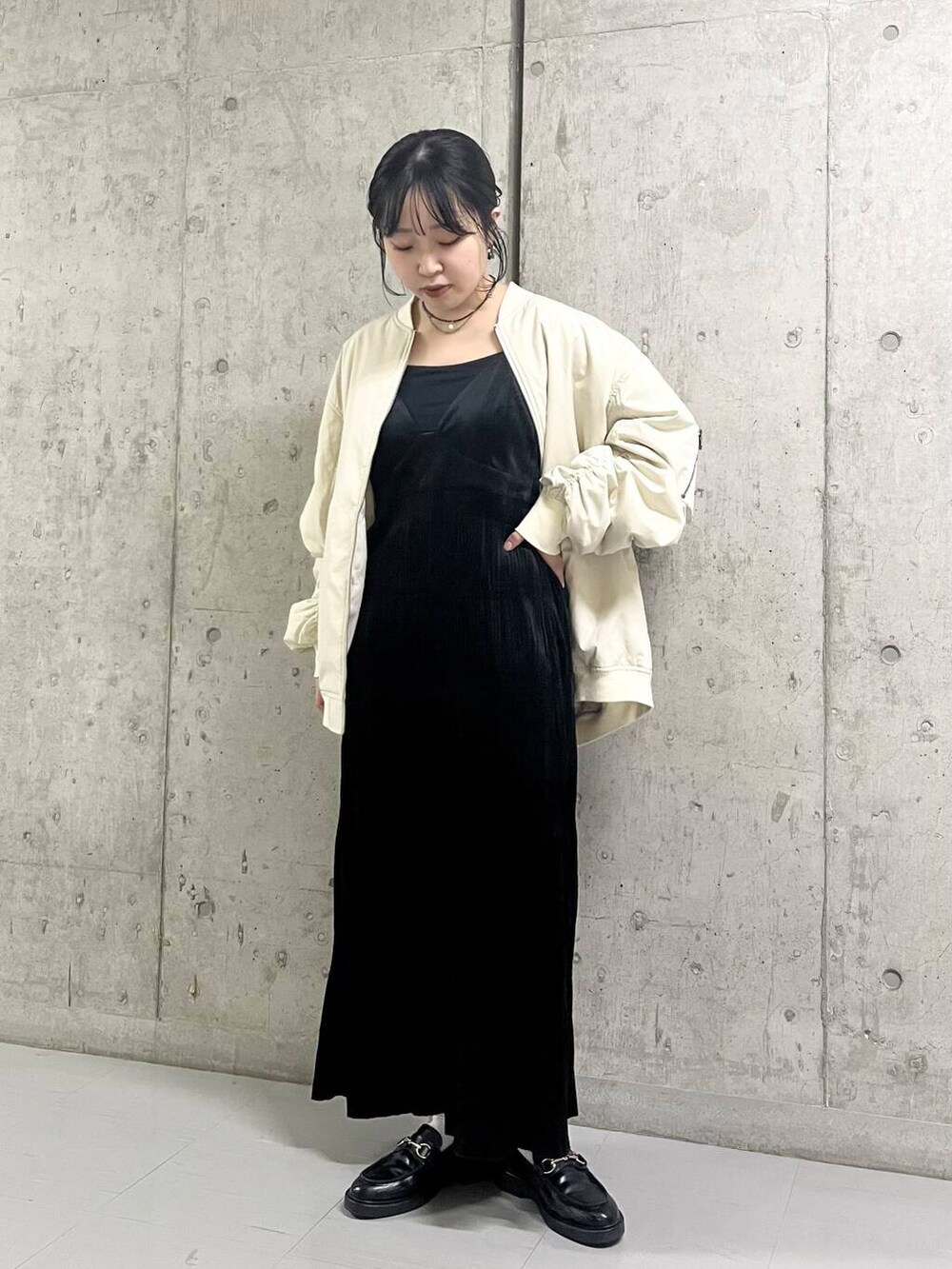ホワイト系のMA-1、ブラック系のワンピースを着用したレディースの秋コーディネートの2枚目の写真