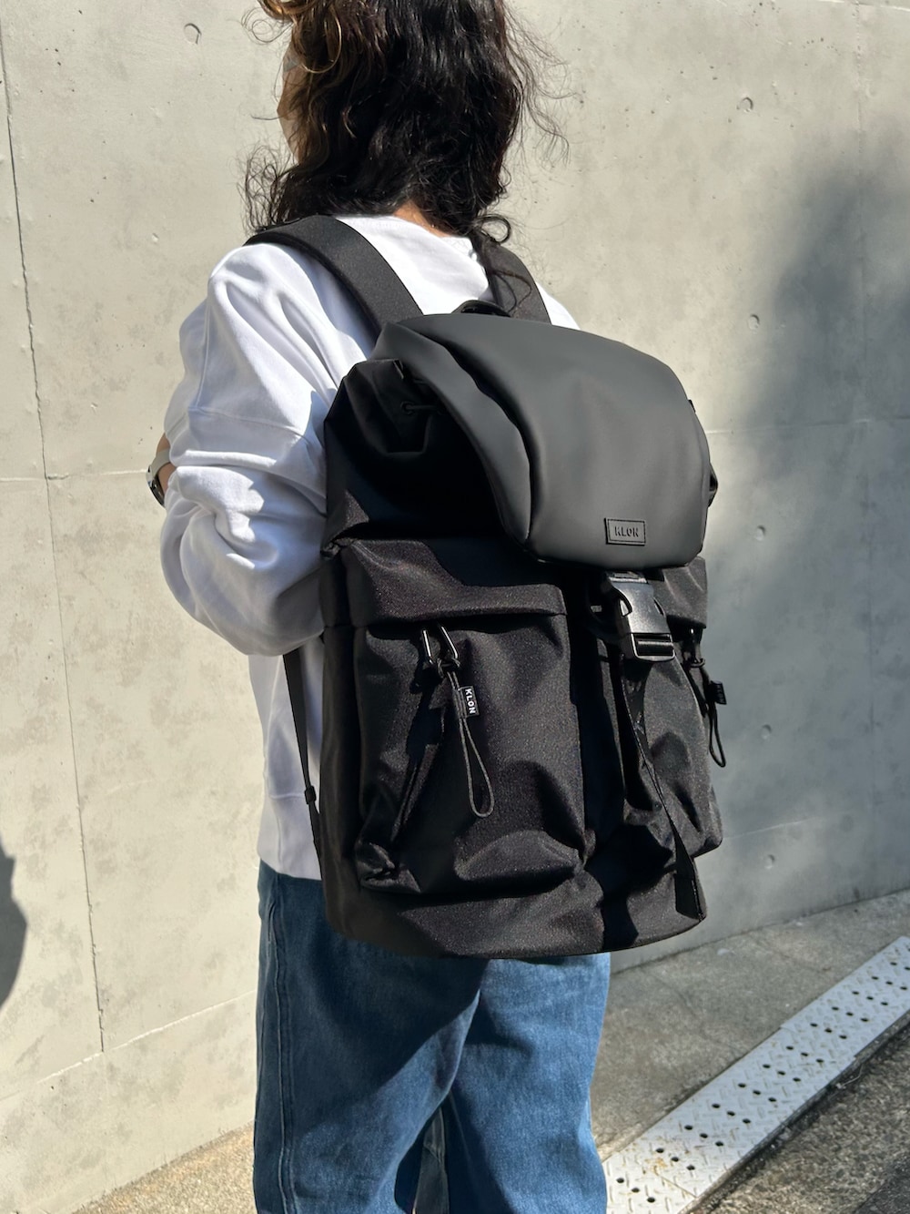 ブラック系のバックパック/リュック、ホワイト系のスウェット、ブラック系のアナログ腕時計を着用したレディースの春コーディネートの2枚目の写真