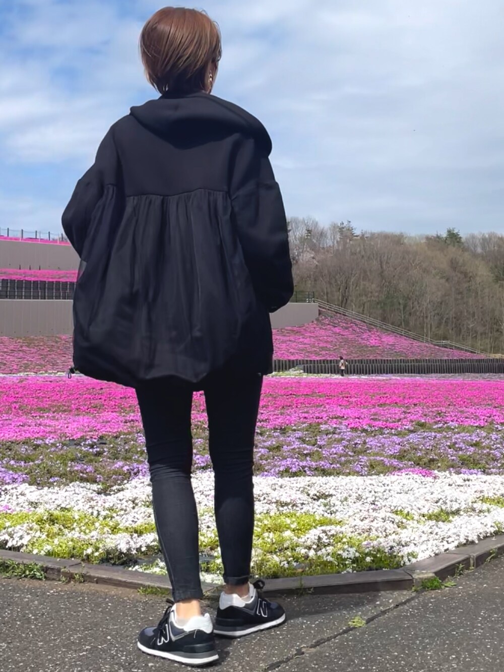 ブラック系のデニムパンツ、グレー系のスウェット、ブラック系のブルゾンを着用したレディースの春コーディネートの2枚目の写真