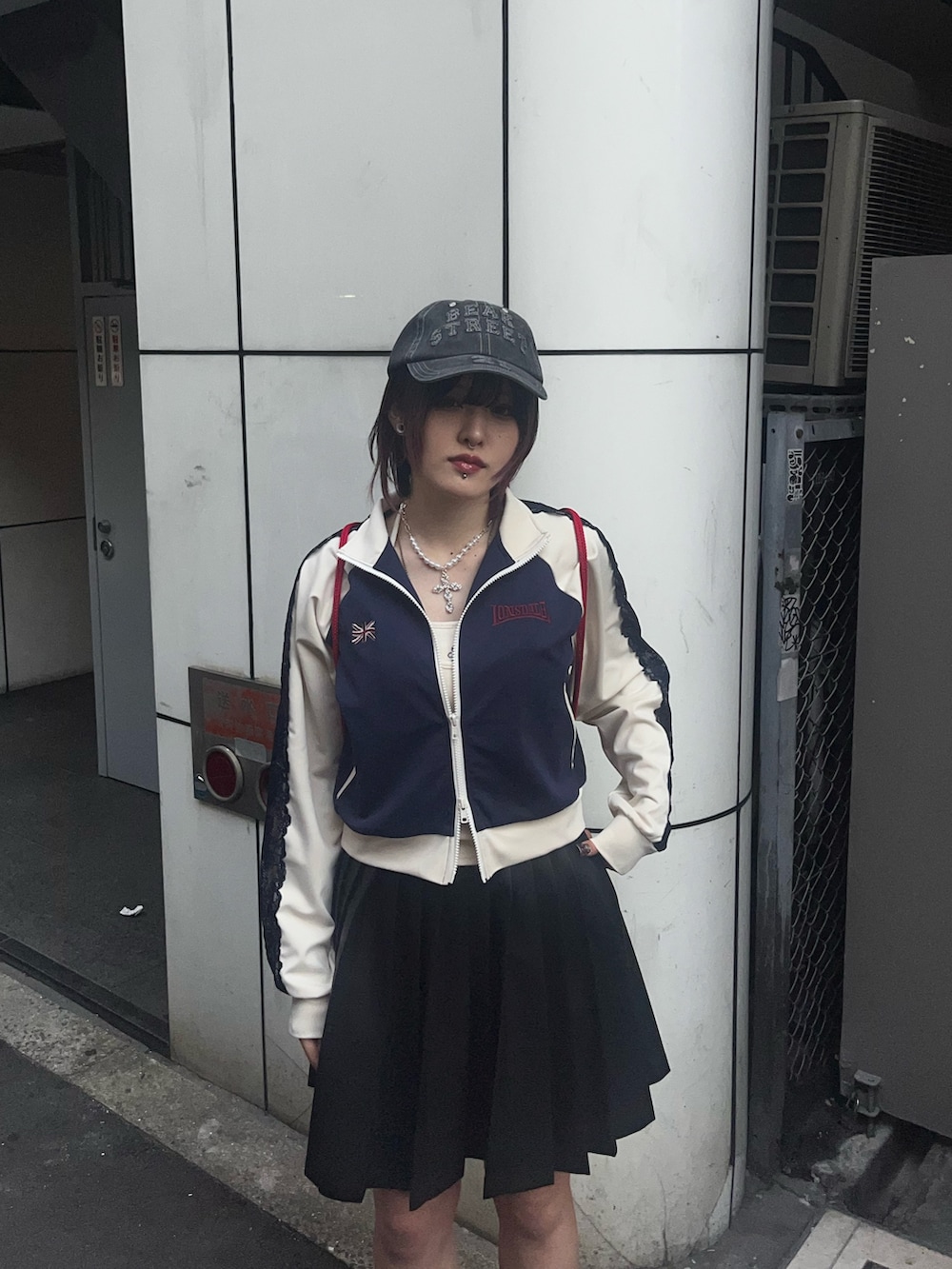 ブラック系のスカート、ブルー系のジャージ、ホワイト系のキャミソールを着用したレディースの春コーディネートの6枚目の写真