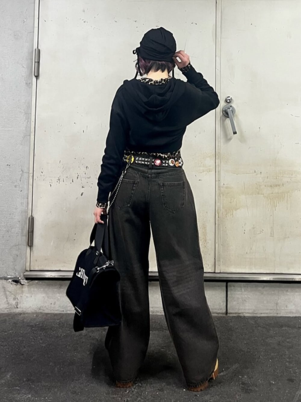 ブラック系のパーカー、ブラウン系のカーディガン/ボレロ、ブラック系のデニムパンツを着用したレディースの春コーディネートの3枚目の写真