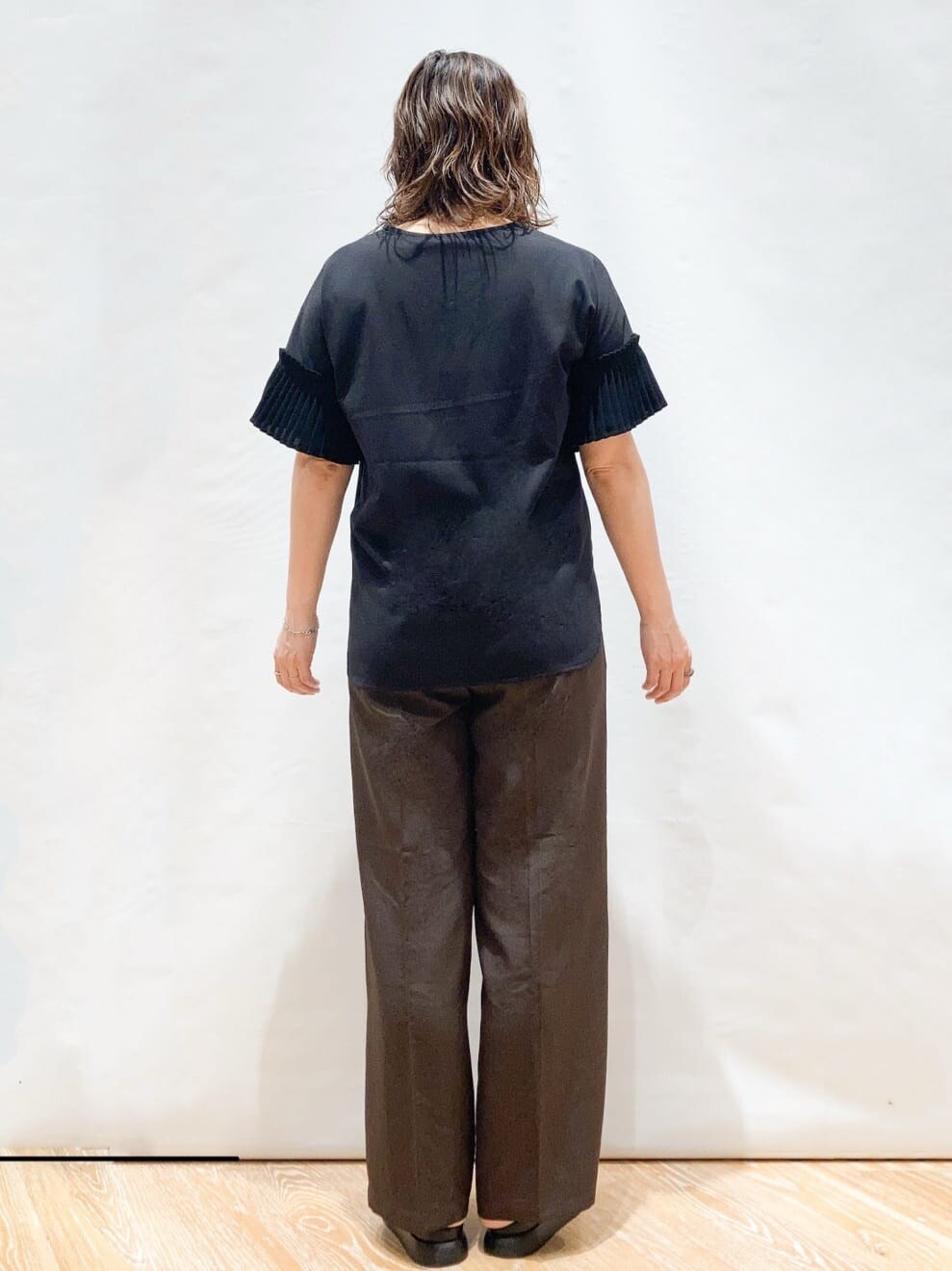 ブラック系のTシャツ/カットソー、ブラウン系のその他パンツ、ブラック系のショルダーバッグを着用したレディースの夏コーディネートの3枚目の写真