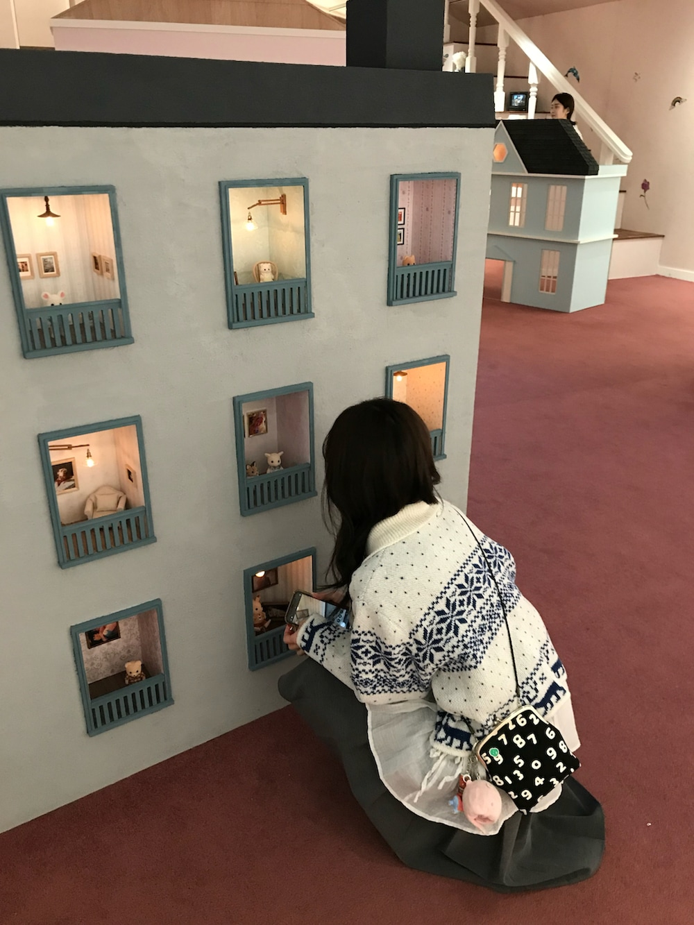 ホワイト系のダウンジャケット/コート、グレー系のデニムパンツ、グレー系のスカートを着用したレディースの春コーディネートの3枚目の写真