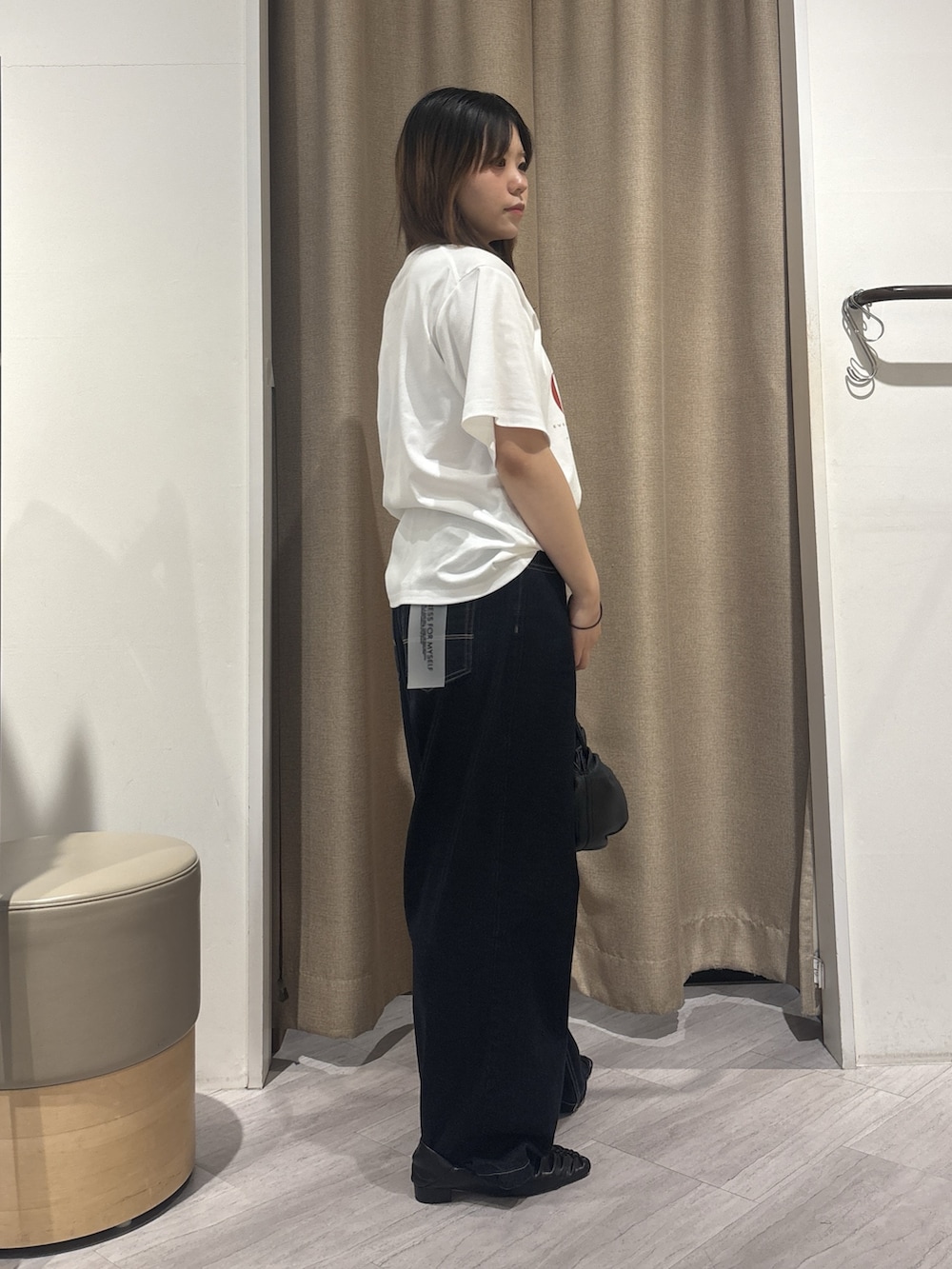 ホワイト系のTシャツ/カットソー、ブルー系のデニムパンツ、ブラック系のトートバッグを着用したレディースの夏コーディネートの2枚目の写真