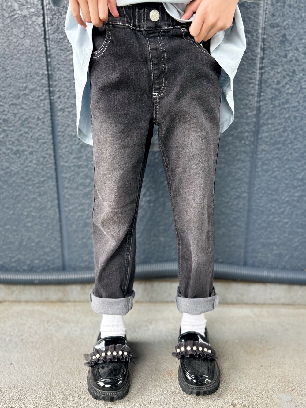 ブルー系のTシャツ/カットソー、ブラック系のデニムパンツ、ブラック系のキャップを着用したレディースの春コーディネートの6枚目の写真