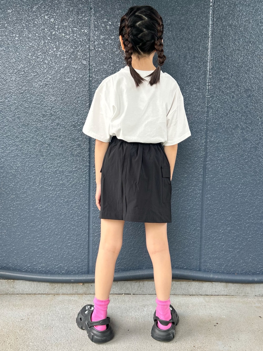 ホワイト系のTシャツ/カットソー、ブラック系のスカート、パープル系のショルダーバッグを着用したレディースの春コーディネートの3枚目の写真