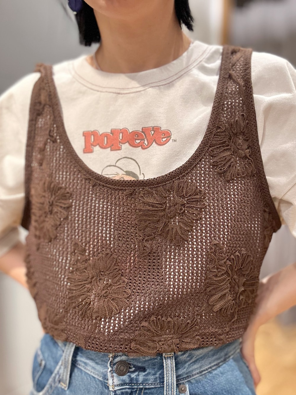 ホワイト系のTシャツ/カットソー、ブルー系のデニムパンツ、ブラウン系のベストを着用したレディースの春コーディネートの5枚目の写真