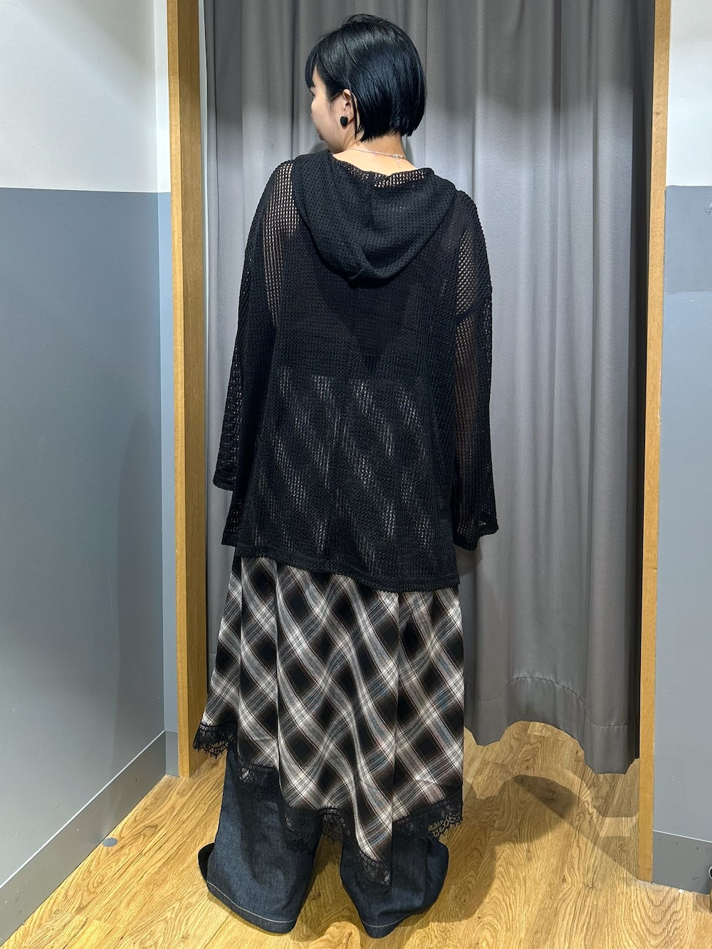 ブラウン系のタンクトップ、ブラック系のTシャツ/カットソー、ブラック系のスカートを着用したレディースの秋コーディネートの3枚目の写真